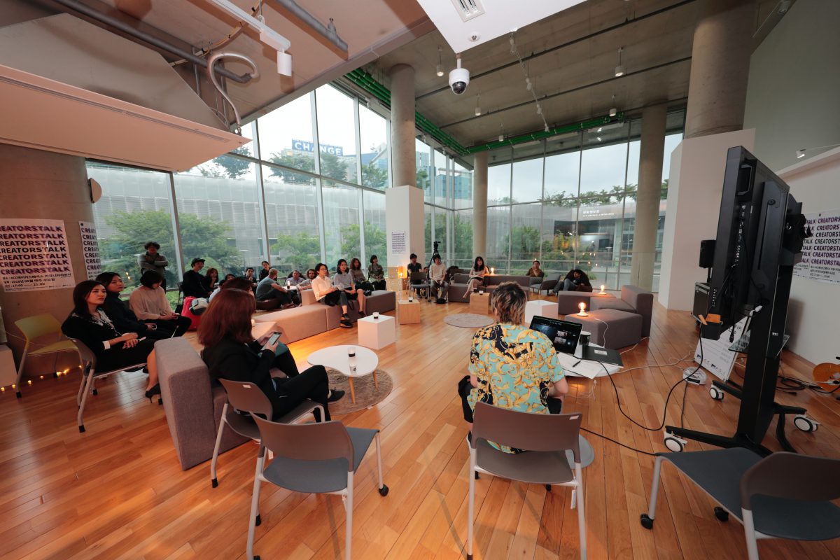 Meeting/discussion room with large windows and people sitting